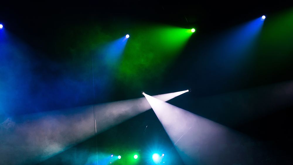 Green, blue and white stage spotlights and smoke