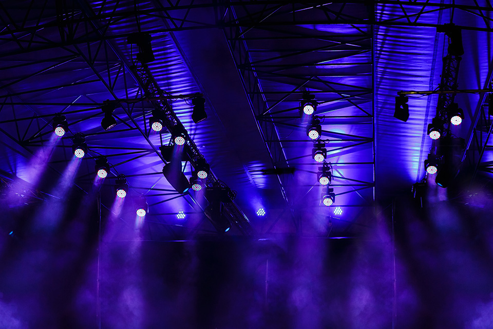 Blue colored spotlights in the theatre roof, smoky background